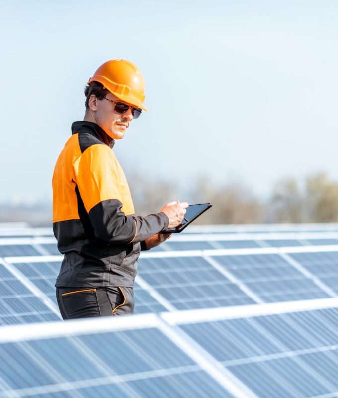 engineer-servicing-solar-panel-on-electric-plant.jpg